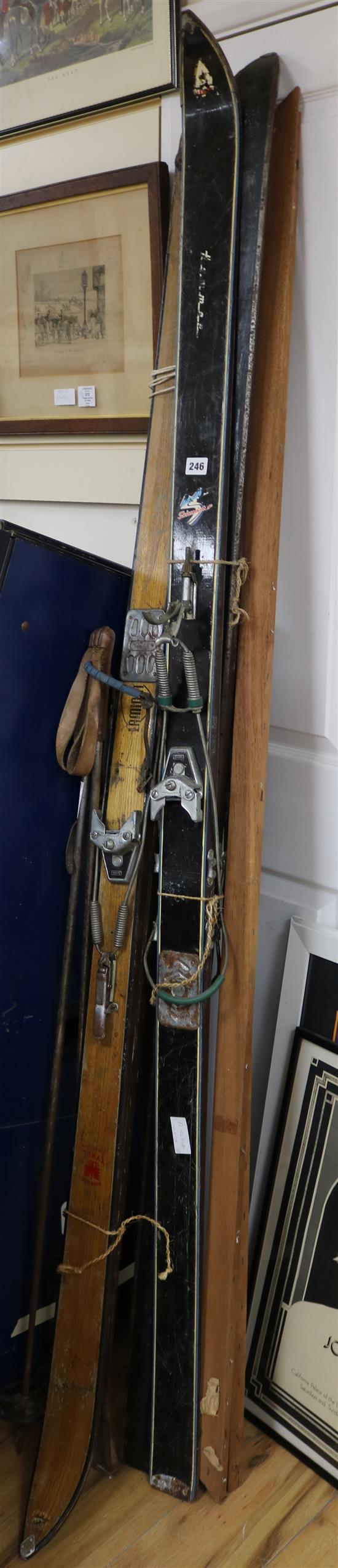 Two pairs of early 20th century skis and poles